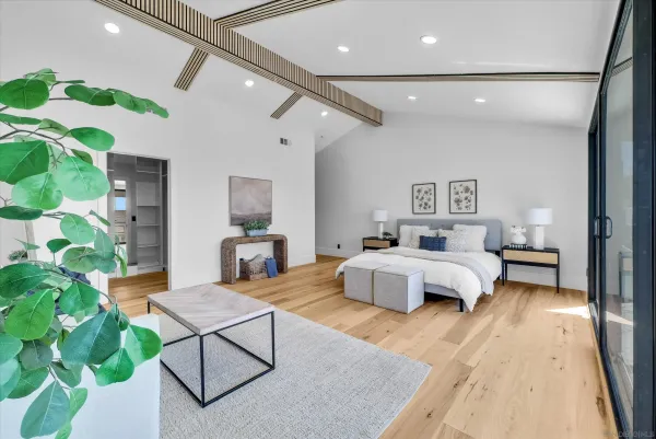 a spacious bedroom with a bed and a couch