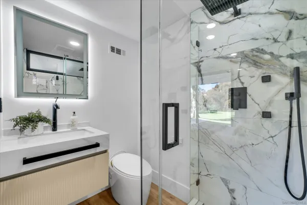 a bathroom with a sink toilet and shower
