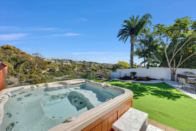 a view of a backyard with plants and lake view