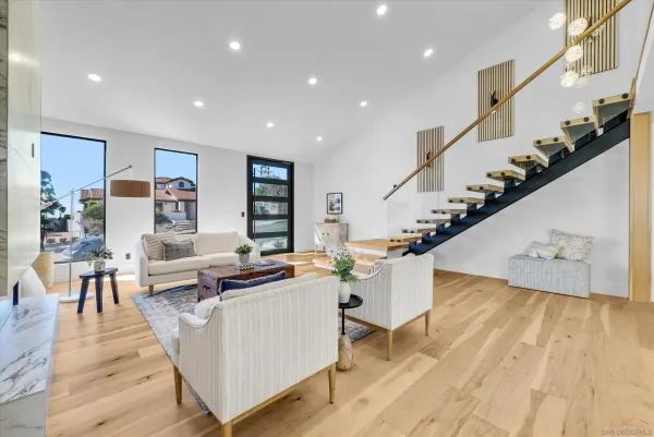 a living room with furniture and wooden floor