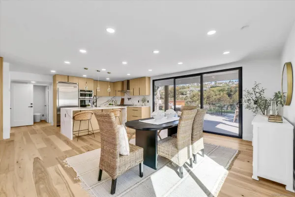 a view of a kitchen with dining table and chairs