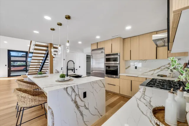 a kitchen with stainless steel appliances kitchen island granite countertop a sink and cabinets