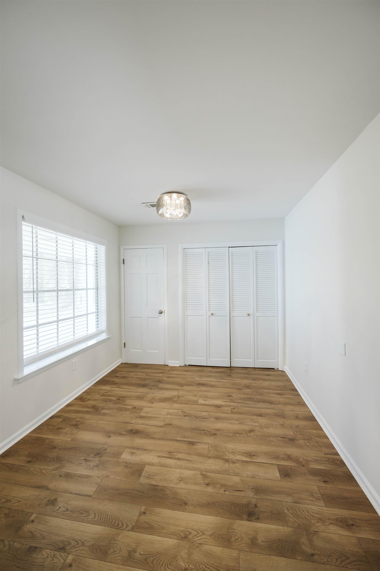 360 Burley Road Collierville, TN 38017 - Photo 12 of 21 wooden floor in an empty room with a window