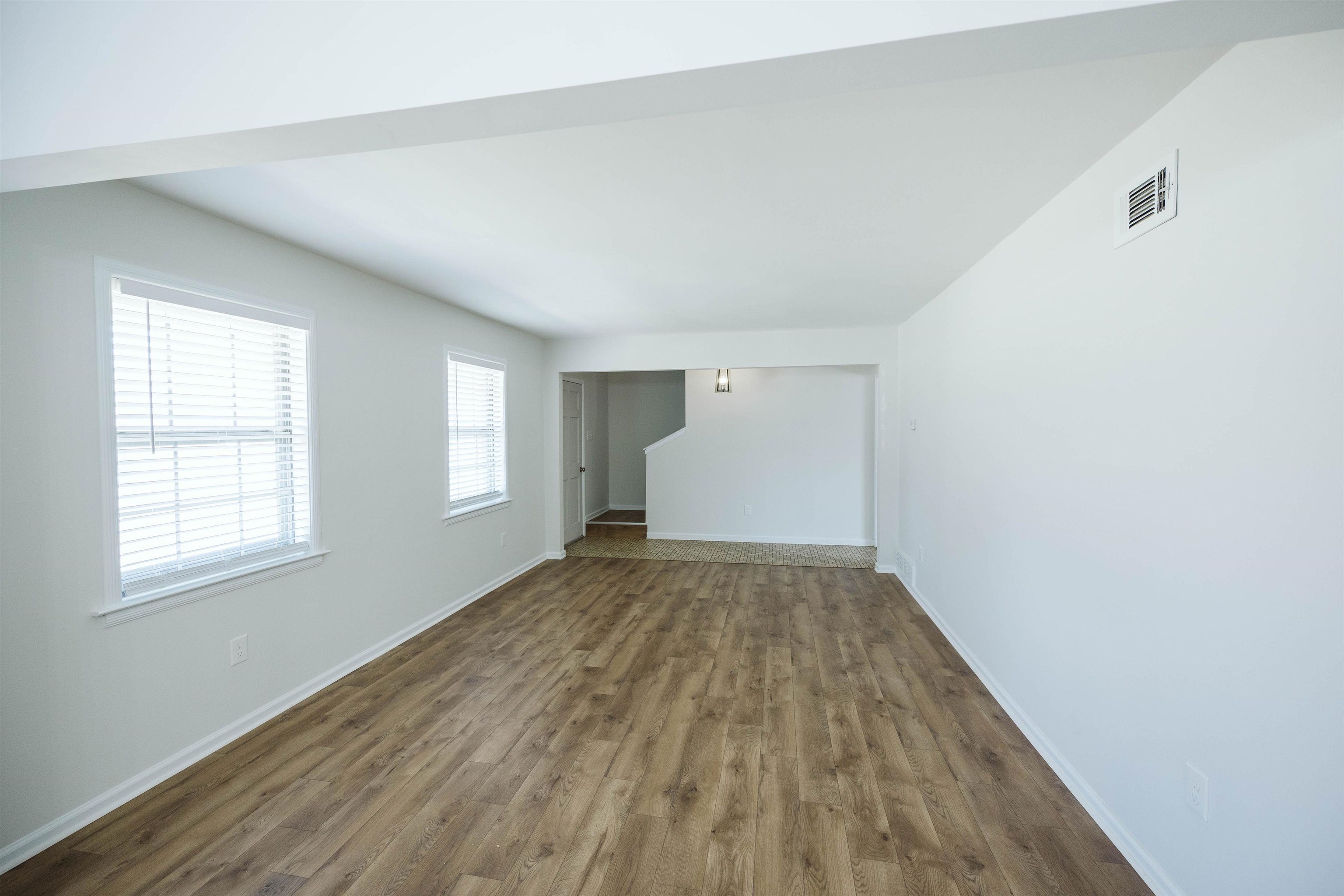 360 Burley Road Collierville, TN 38017 - Photo 10 of 21 an empty room with wooden floor and windows