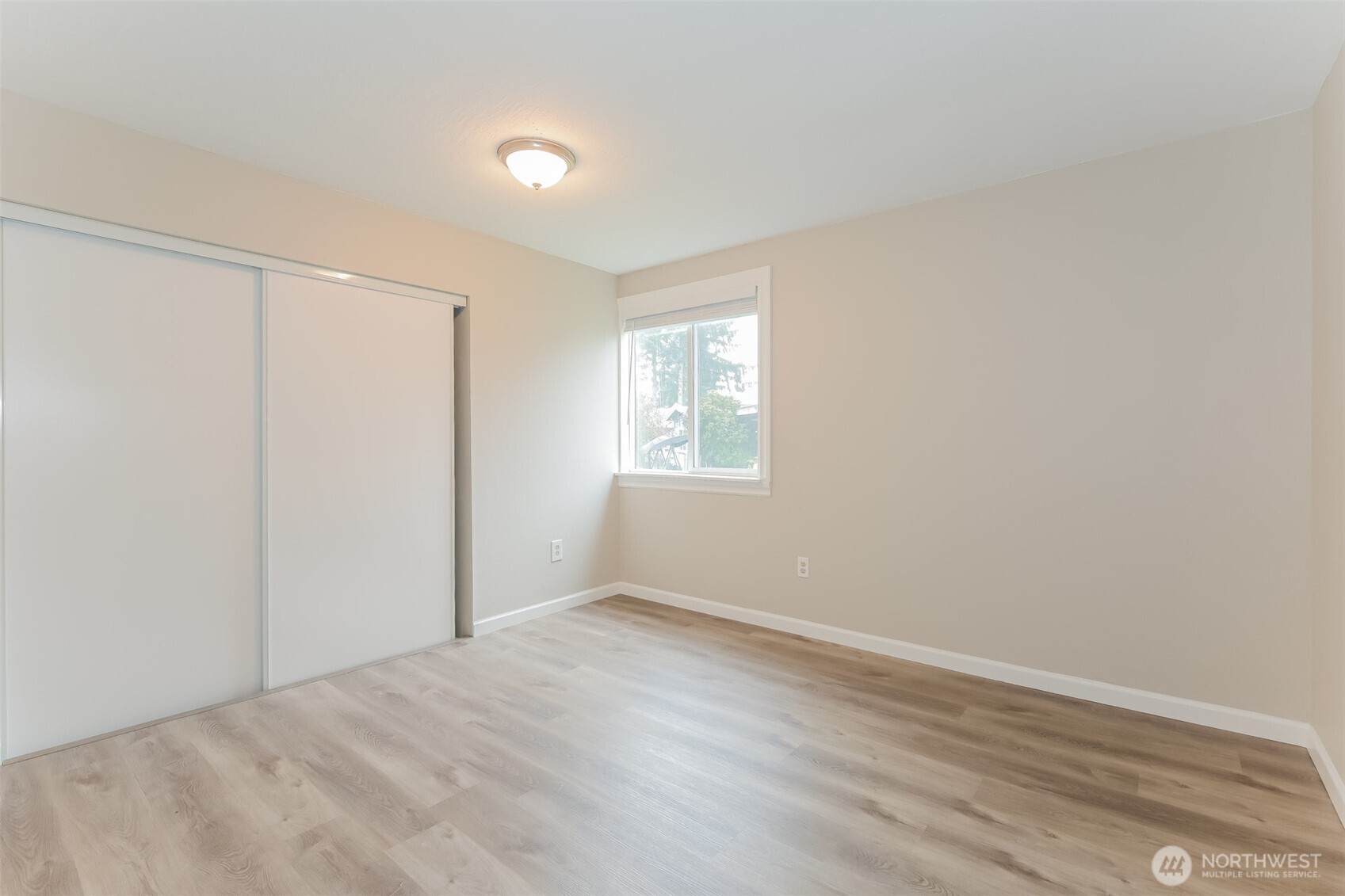 2611 Southwest 333rd Place Federal Way, WA 98023 - Photo 7 of 16 a view of an empty room with wooden floor and a window