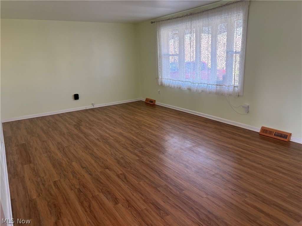 64197 Morrison Road Cambridge, OH 43725 - Photo 14 of 41 Unfurnished room with vaulted ceiling and dark hardwood / wood-style floors