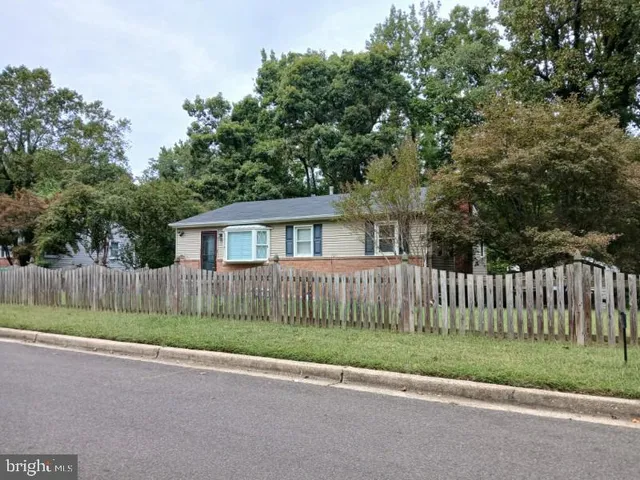a view of a house with a yard and a fence