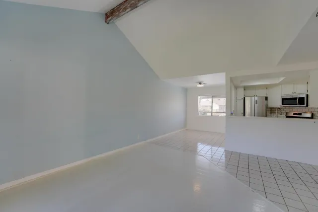 a view of a livingroom and a kitchen with a sink