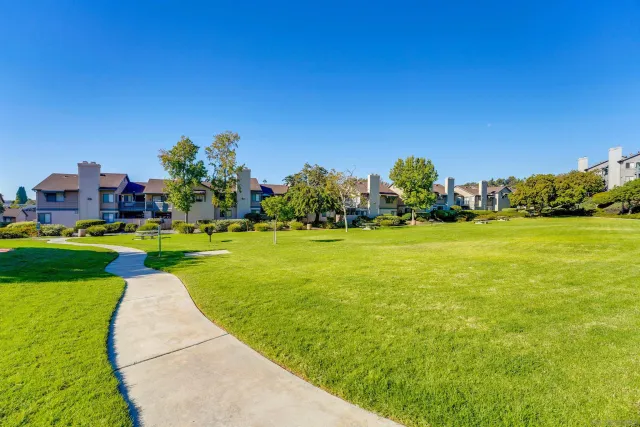 a view of a garden with a building in the background