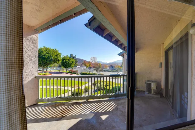 a view of a street with a balcony