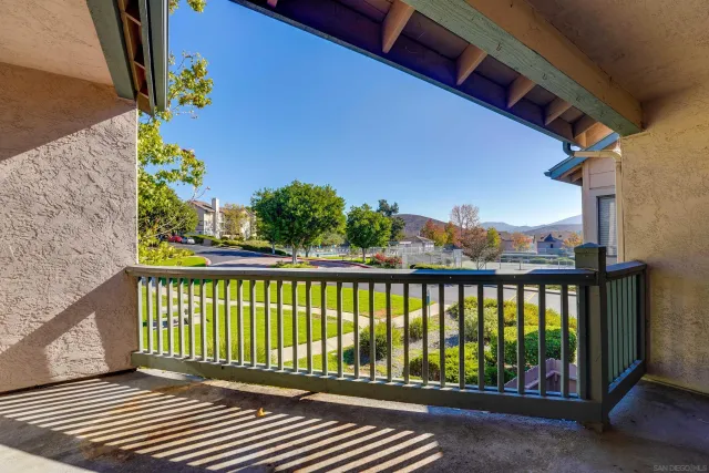 a view of a balcony with wooden floor