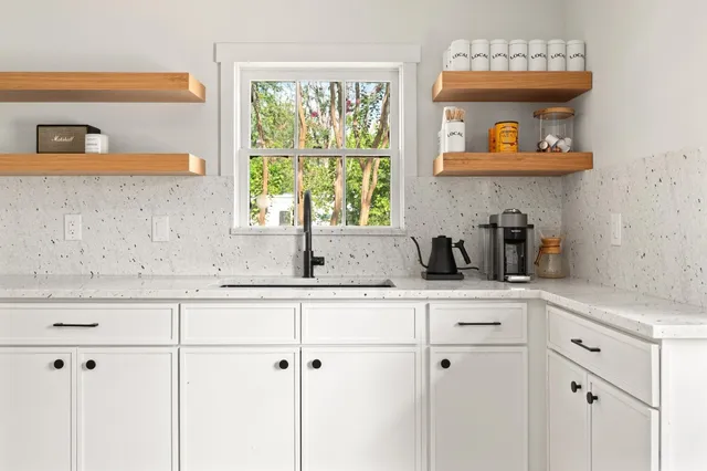 a kitchen with a cabinets a sink and a window