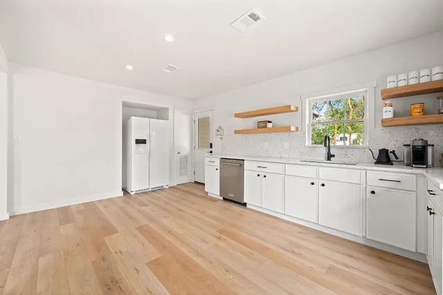 a kitchen with a sink cabinets and window