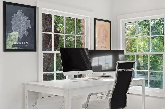 a kitchen with a window a sink and a microwave