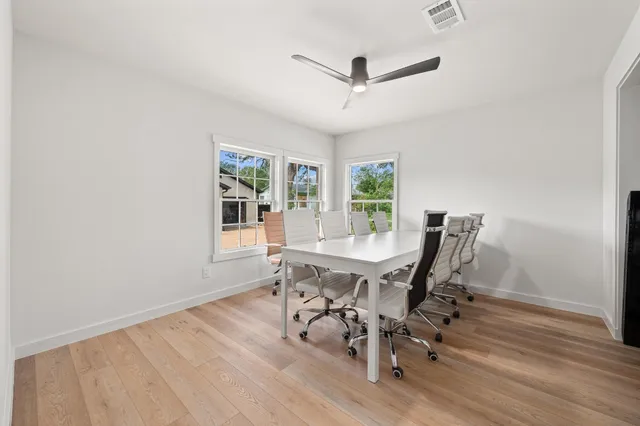 a view of a workspace with furniture window and wooden floor
