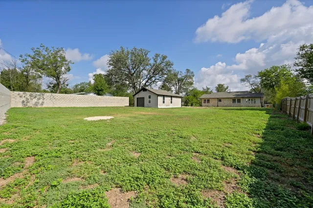 a view of yard with swimming pool and green space