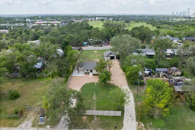 an aerial view of a house with yard