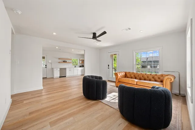 a living room with furniture and a wooden floor
