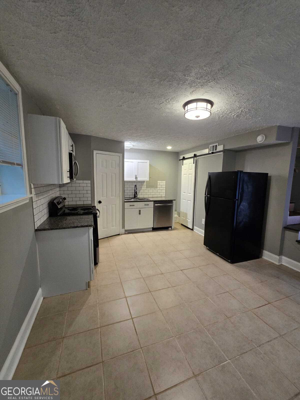 2963 Redwine Road, Unit REAR East Point, GA 30344 - Photo 3 of 9 a kitchen with a refrigerator and a stove top oven