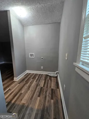 a view of a room with wooden floor and window