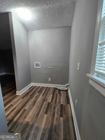 a view of a room with wooden floor and window