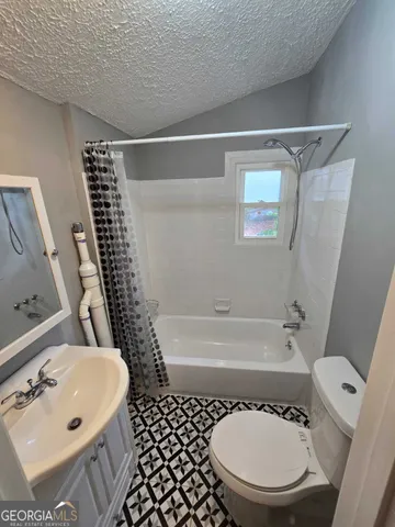 a bathroom with a bathtub and a sink