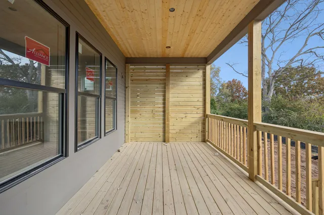 a view of house with a small yard and wooden fence