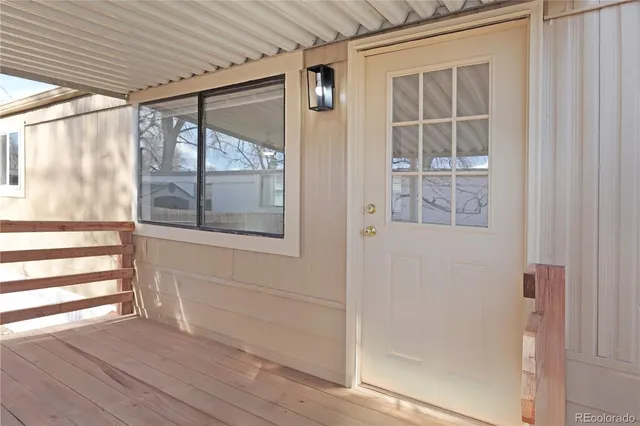 a view of front door and deck of the house