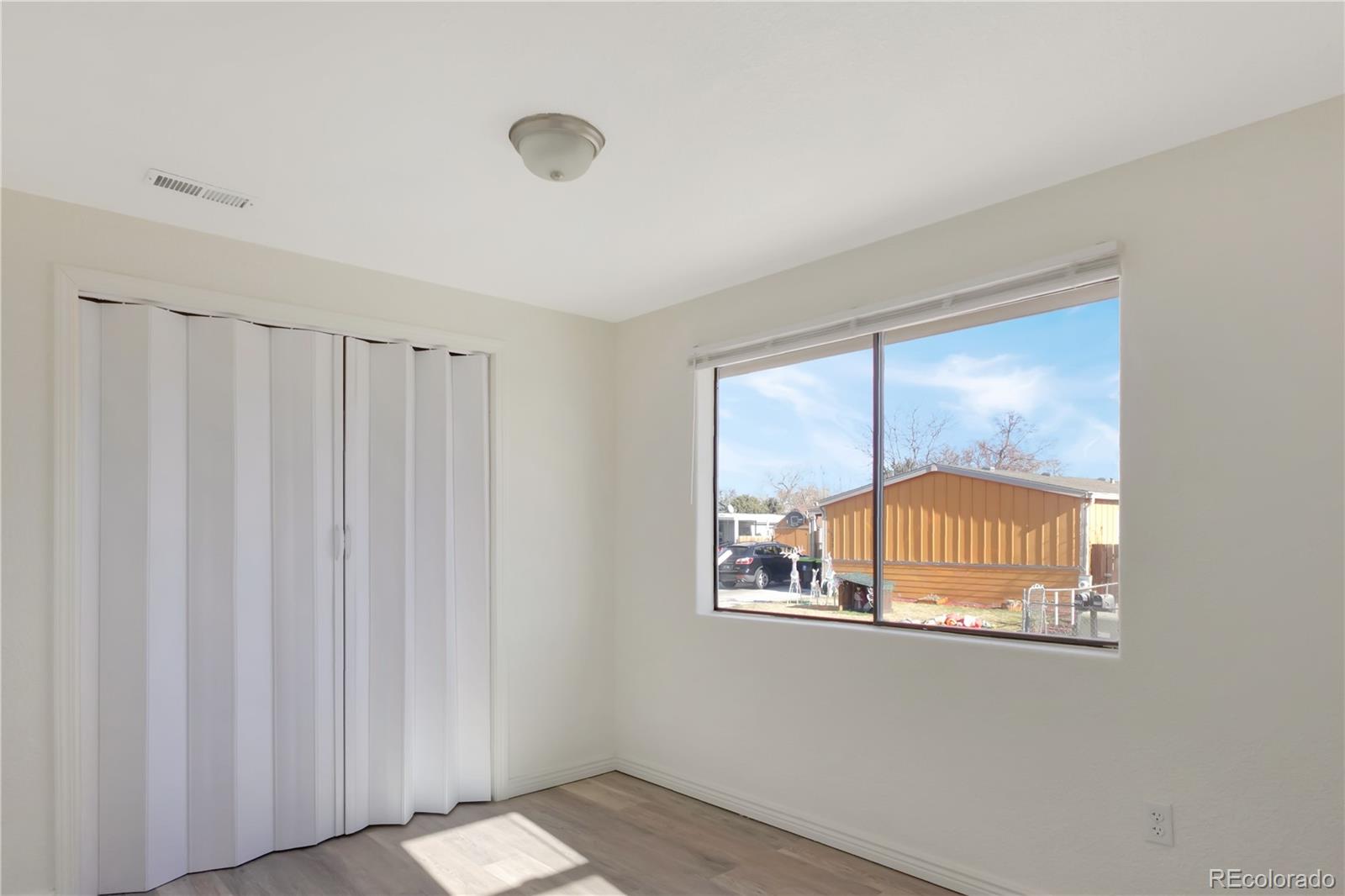 8533 Cook Court Denver, CO 80229 - Photo 7 of 15 a view of an empty room with a window