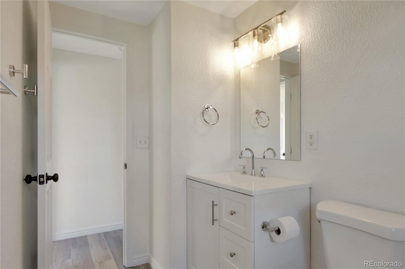 8533 Cook Court Denver, CO 80229 - Photo 9 of 15 a bathroom with a sink a toilet and shower