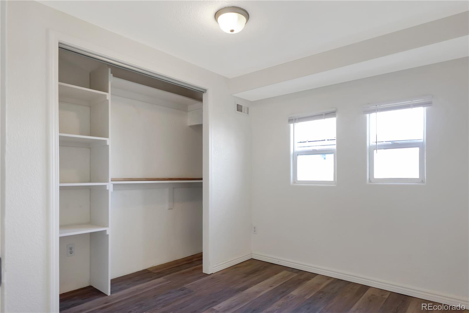 8533 Cook Court Denver, CO 80229 - Photo 10 of 15 a view of an empty room with wooden floor and a window