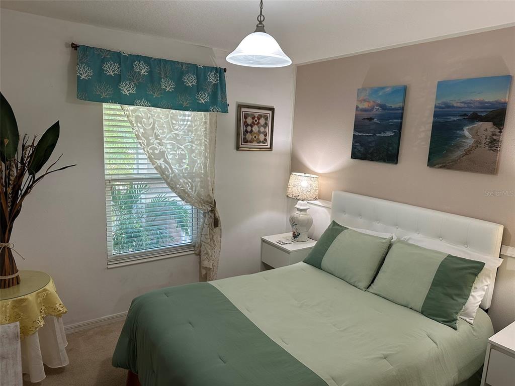 Undisclosed Address Tavares, FL 32778 - Photo 17 of 29 a bedroom with a bed and a window