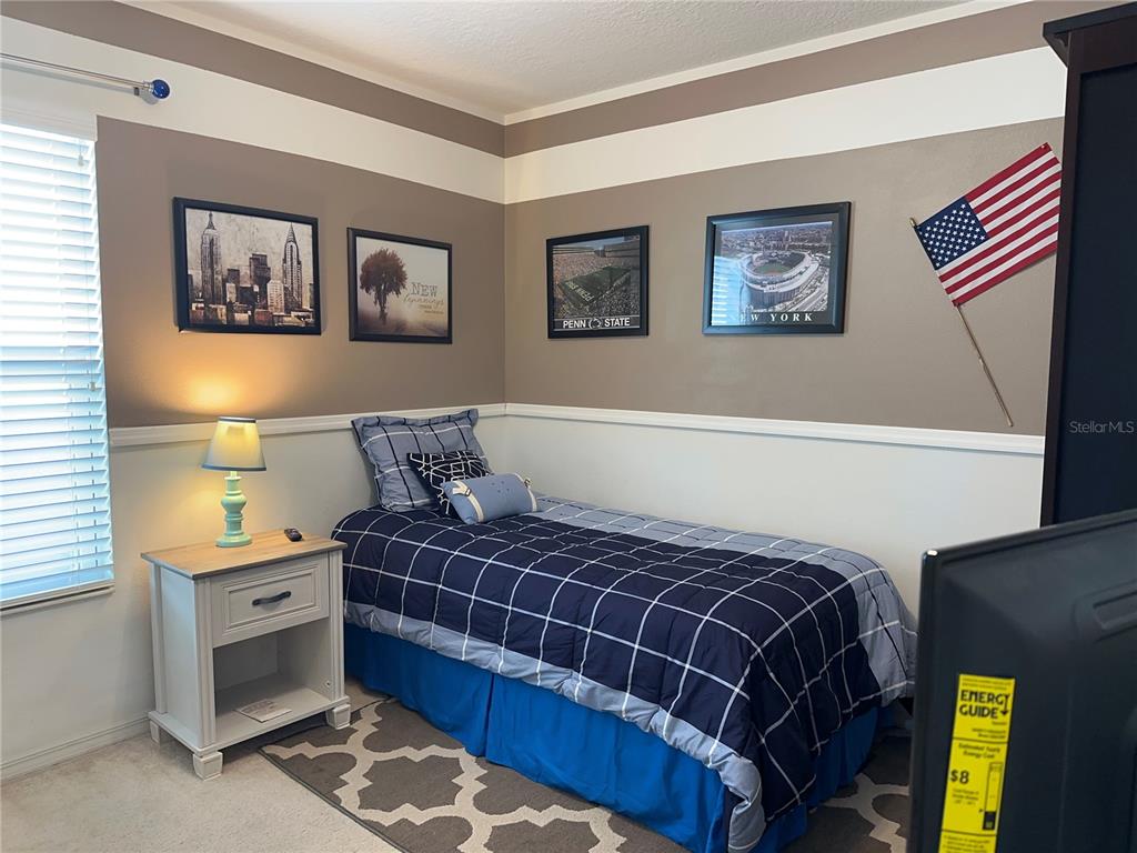 Undisclosed Address Tavares, FL 32778 - Photo 18 of 29 a bedroom with a bed and painting on the wall