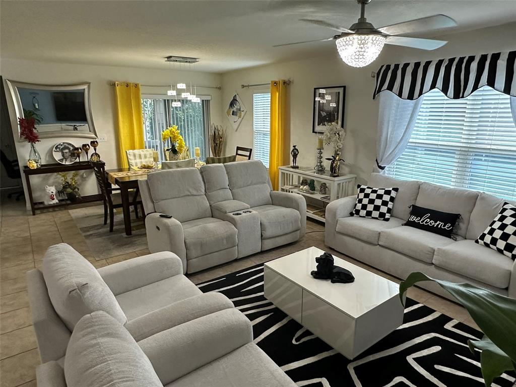 Undisclosed Address Tavares, FL 32778 - Photo 3 of 29 a living room with furniture ceiling fan and a window