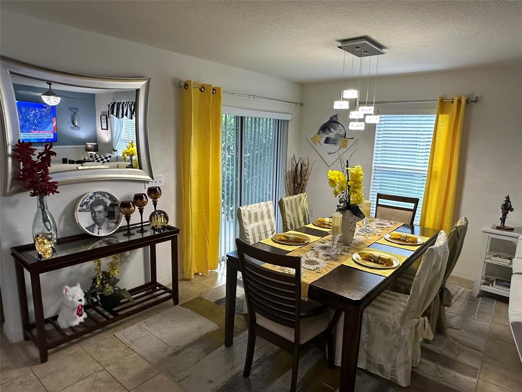 Undisclosed Address Tavares, FL 32778 - Photo 4 of 29 a view of a dining room with furniture and chandelier