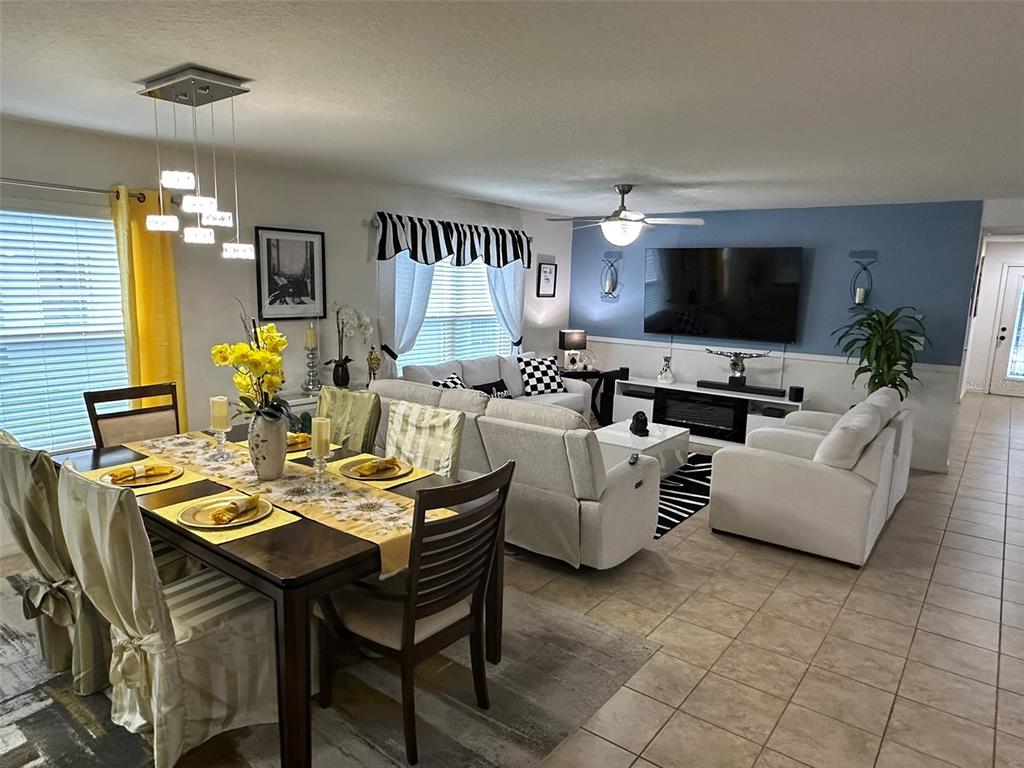 Undisclosed Address Tavares, FL 32778 - Photo 5 of 29 a living room with furniture kitchen view and a flat screen tv