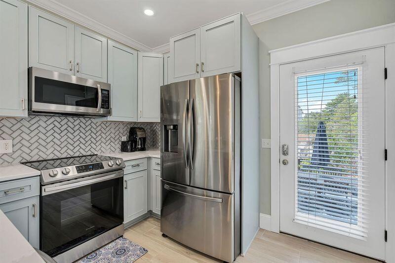 45 Abbey Road Santa Rosa Beach, FL 32459 - Photo 11 of 34 a kitchen with cabinets stainless steel appliances and wooden floor