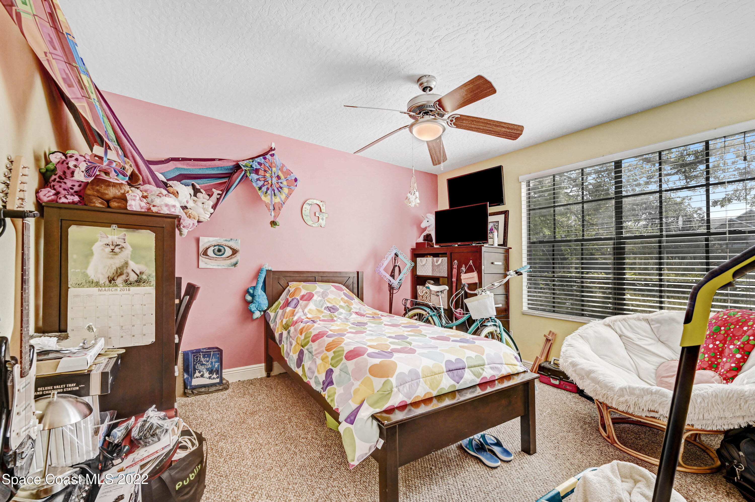 7667 North Wickham Road, Unit 107 Melbourne, FL 32940 - Photo 16 of 26 a bedroom with furniture and a window