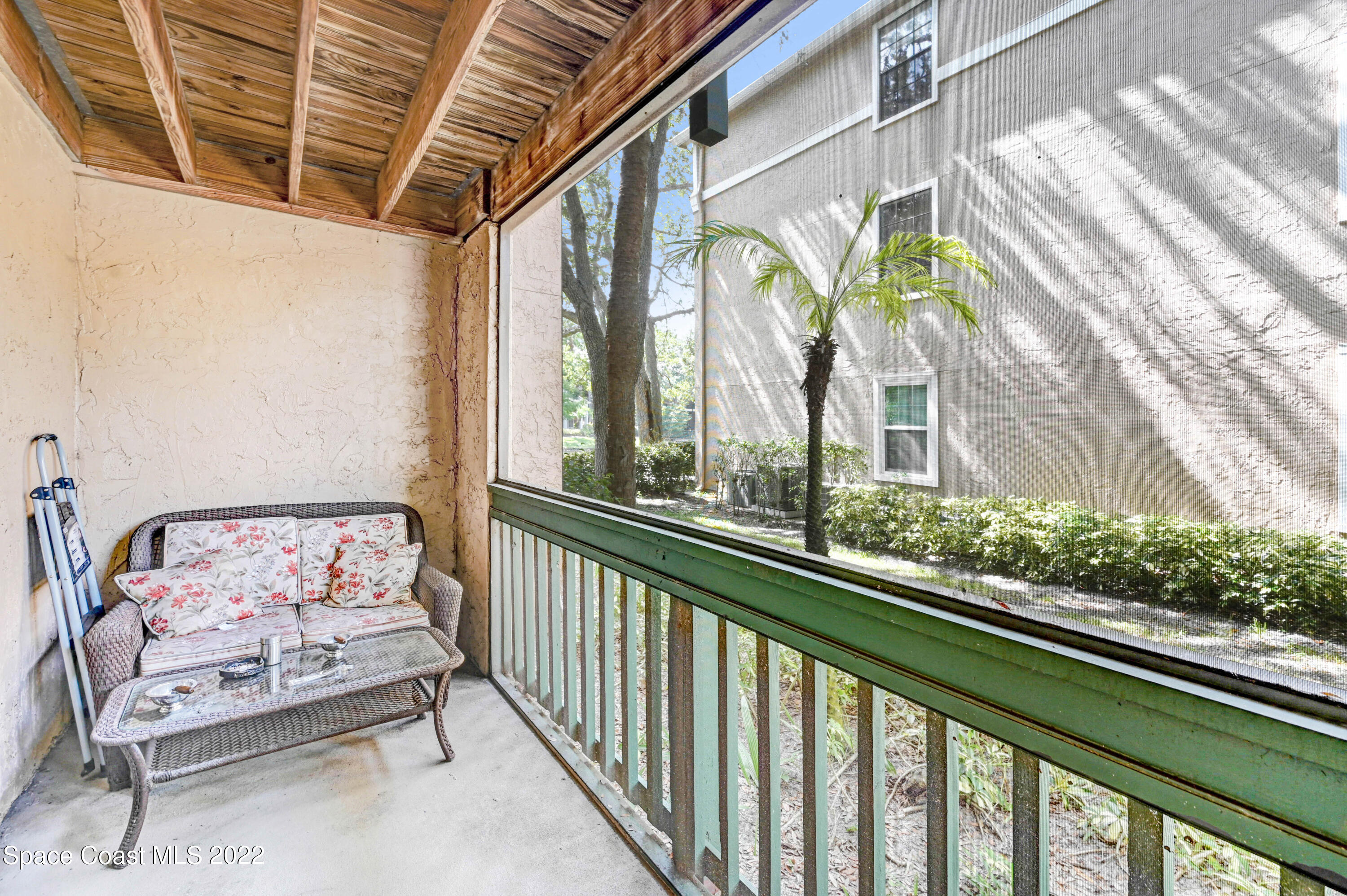 7667 North Wickham Road, Unit 107 Melbourne, FL 32940 - Photo 19 of 26 a view of a porch with furniture