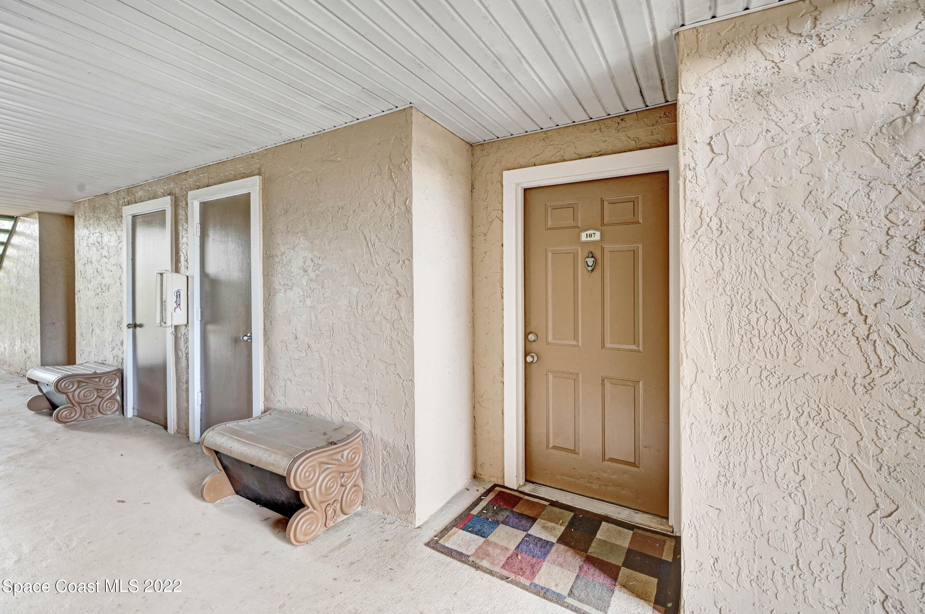 7667 North Wickham Road, Unit 107 Melbourne, FL 32940 - Photo 3 of 26 a living room with furniture and a window