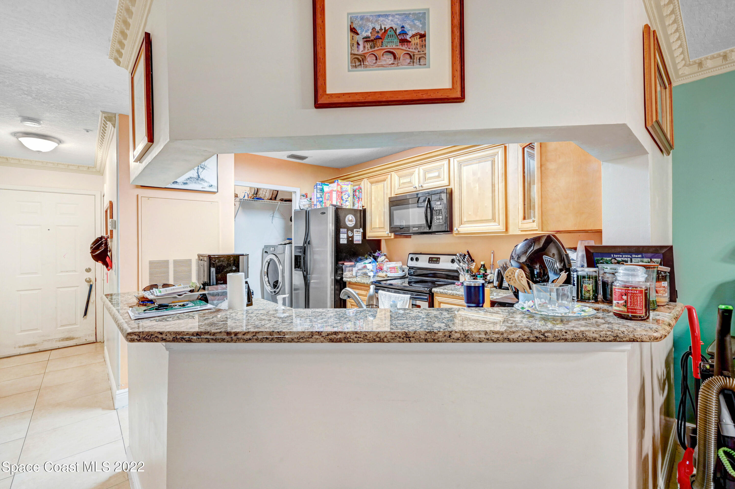7667 North Wickham Road, Unit 107 Melbourne, FL 32940 - Photo 6 of 26 a bathroom with kitchen island granite countertop a large window cabinets and a sink