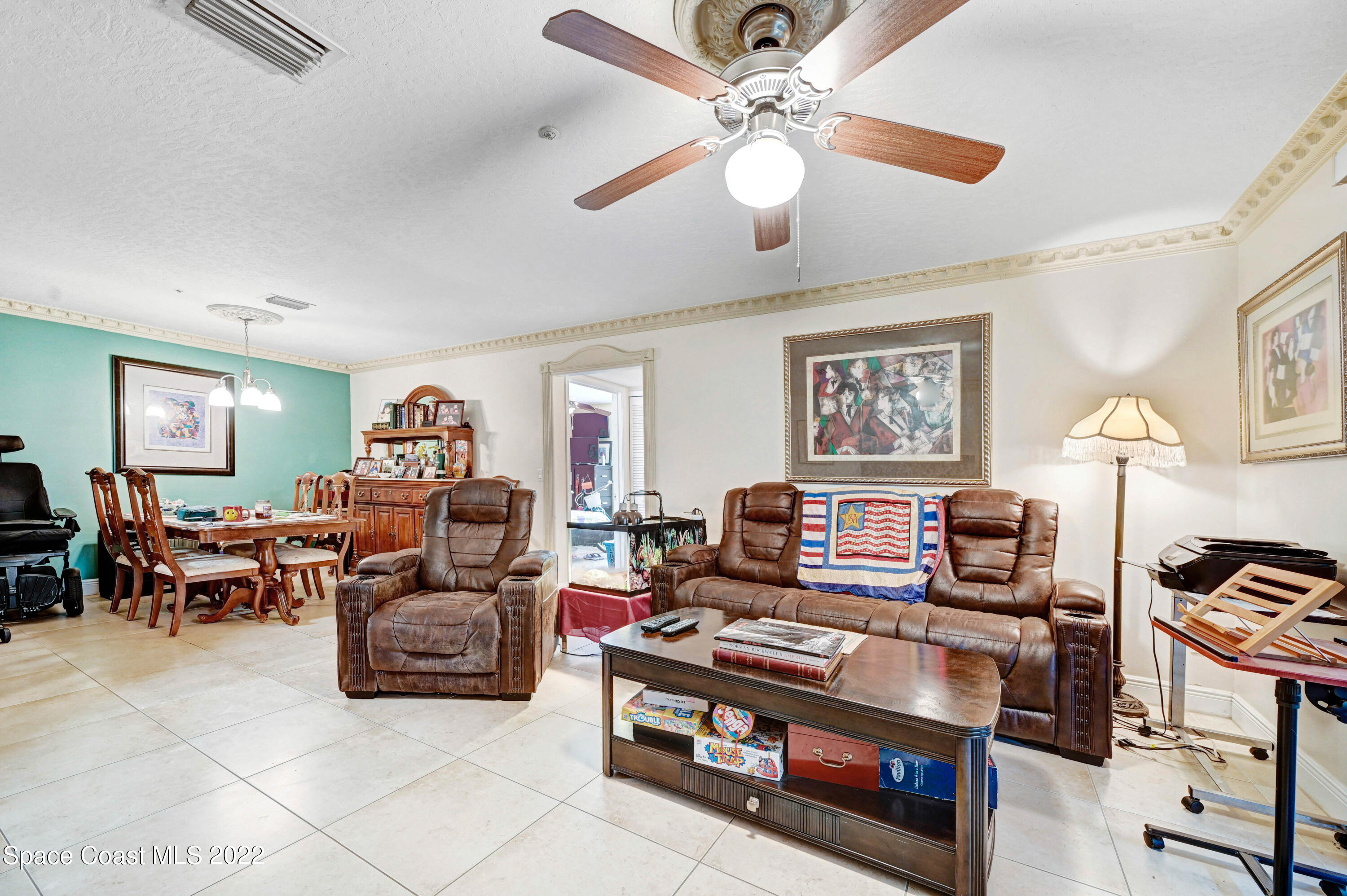 7667 North Wickham Road, Unit 107 Melbourne, FL 32940 - Photo 9 of 26 a living room with furniture and a window