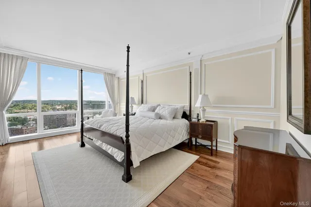 a bedroom with furniture and a flat screen tv