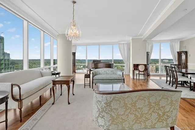 a living room with couches chairs and a large window