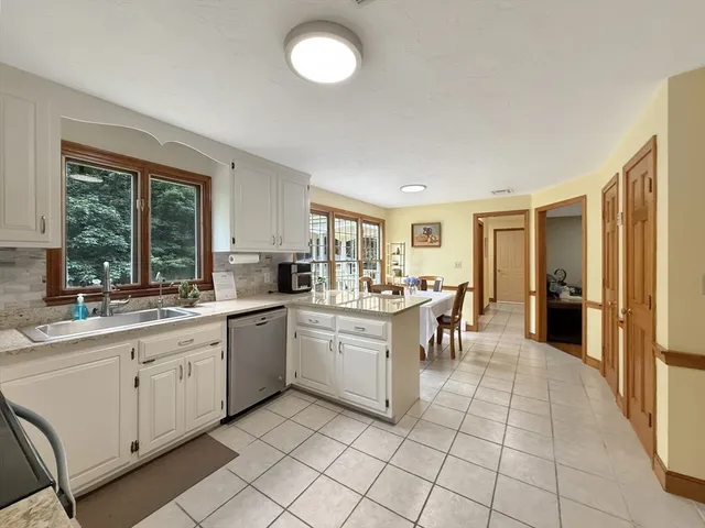 a kitchen with sink cabinets and dining table