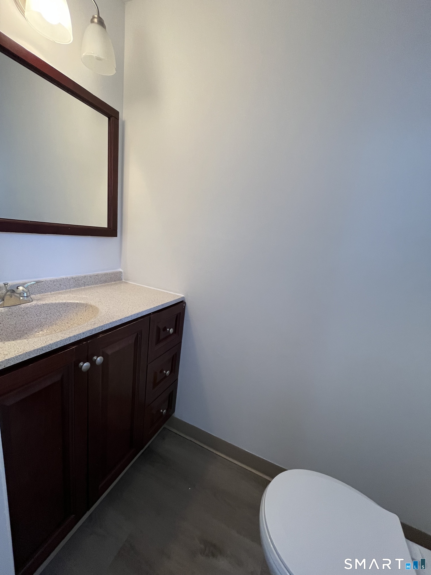 88 East Gate Lane, Unit 88 Hamden, CT 06514 - Photo 13 of 62 a bathroom with a toilet sink vanity and mirror