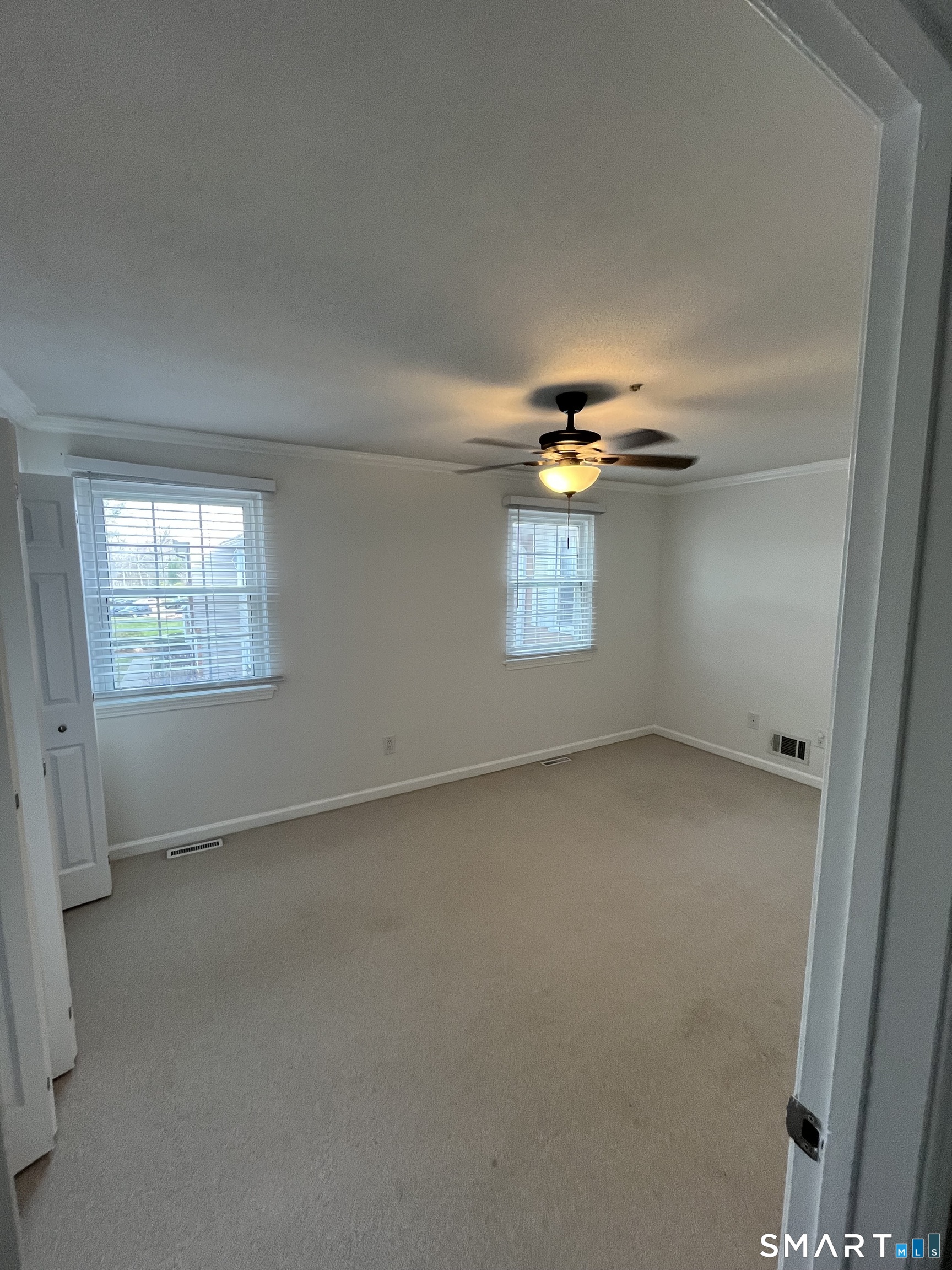 88 East Gate Lane, Unit 88 Hamden, CT 06514 - Photo 16 of 62 en empty room with windows and chandelier fan