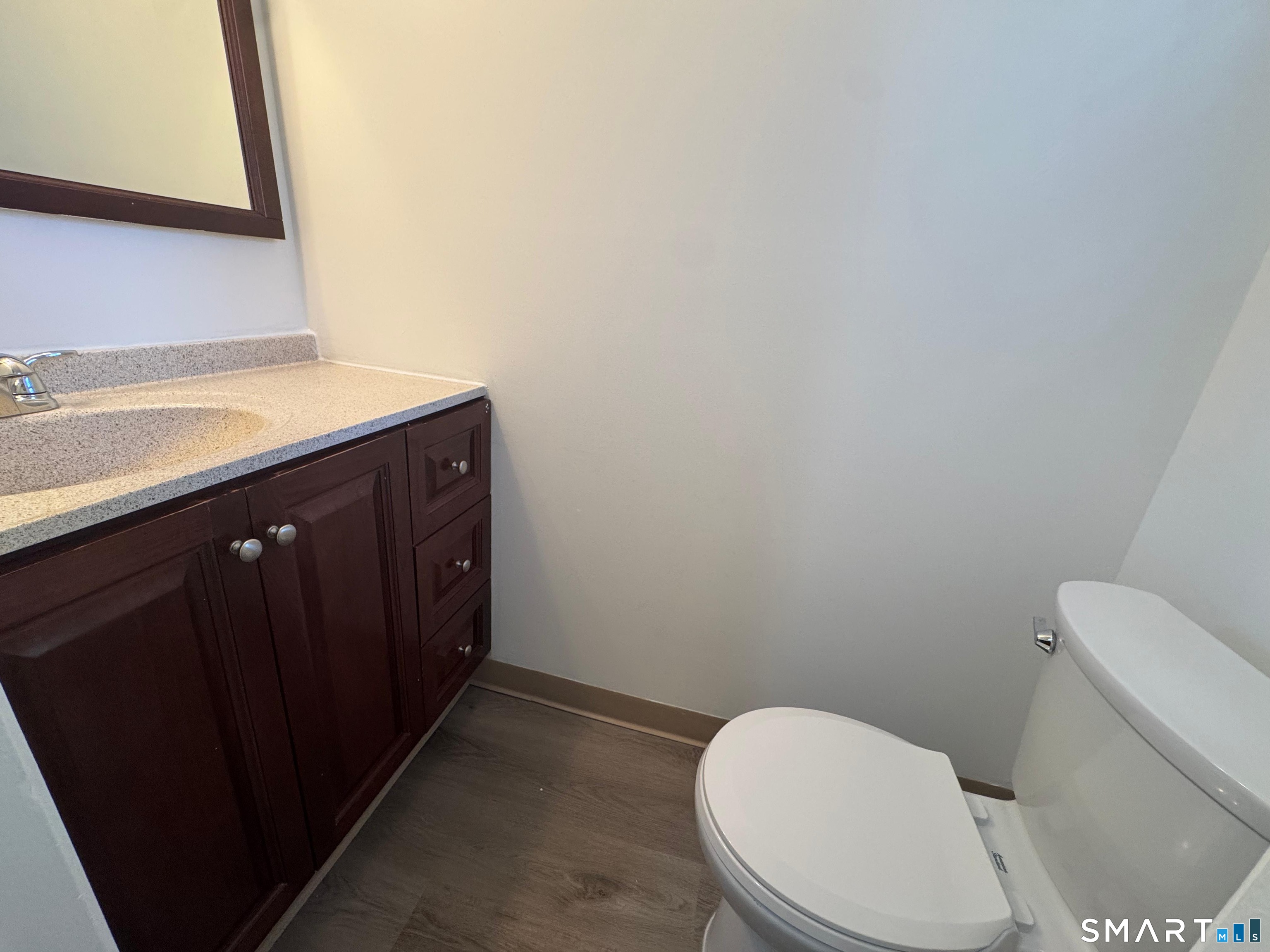 88 East Gate Lane, Unit 88 Hamden, CT 06514 - Photo 18 of 62 a white toilet sitting next to a sink and vanity
