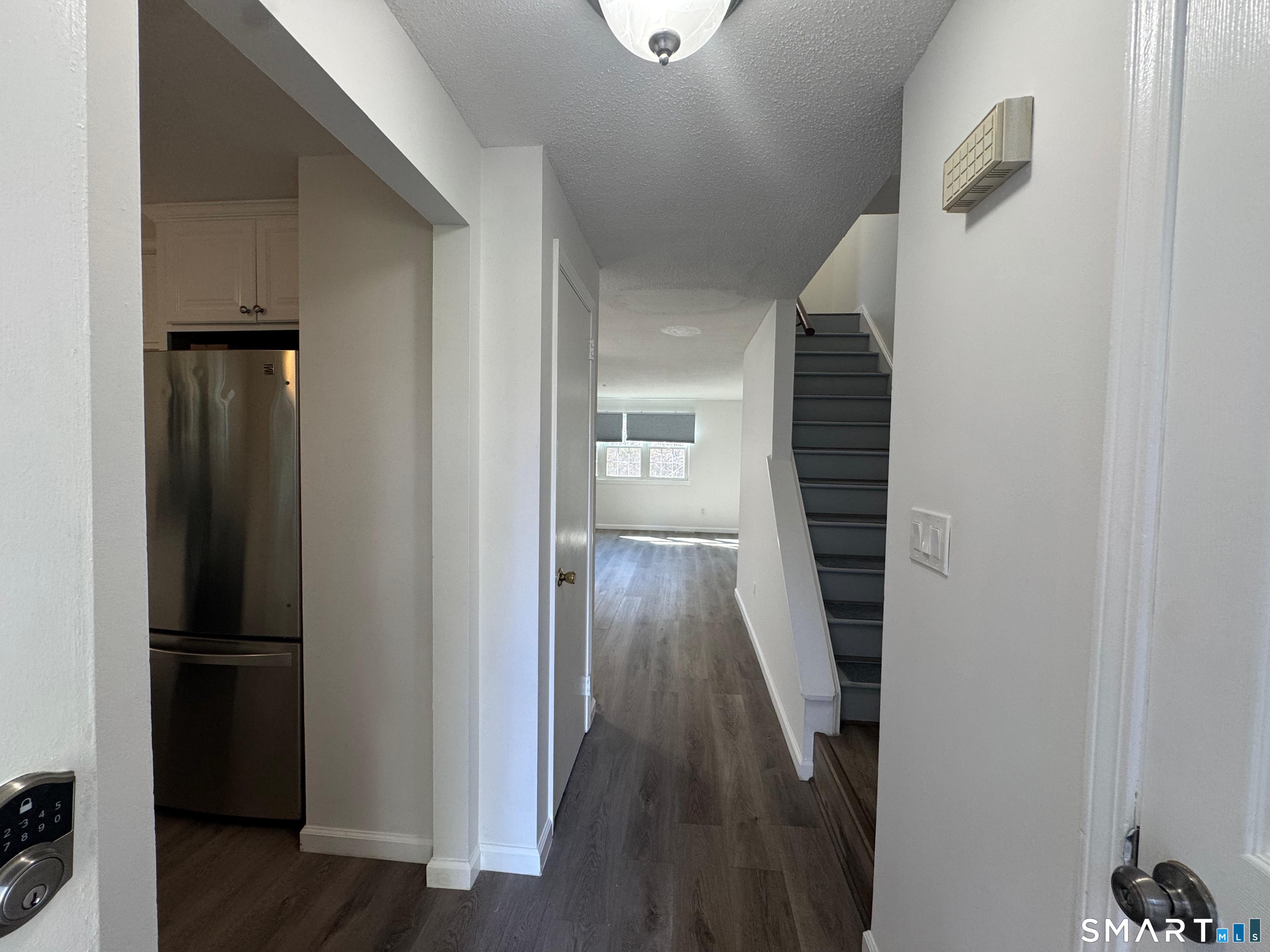 88 East Gate Lane, Unit 88 Hamden, CT 06514 - Photo 19 of 62 a view of a hallway with wooden floor and staircase