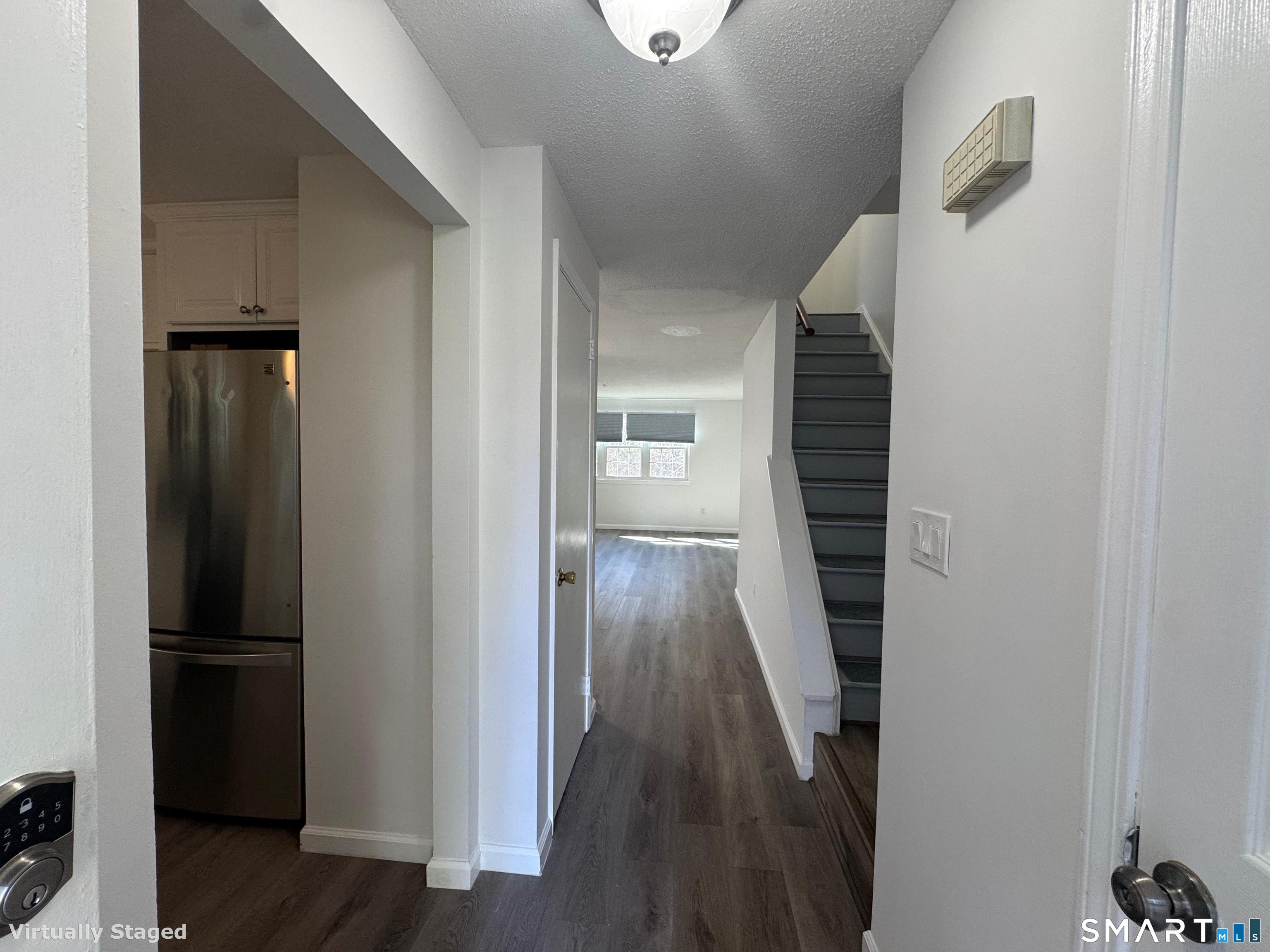88 East Gate Lane, Unit 88 Hamden, CT 06514 - Photo 20 of 62 a view of a hallway with wooden floor and staircase